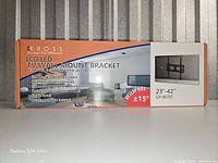 Front of sealed Kross LCD/LED TV wall mount bracket box showing model, size range, tilt feature