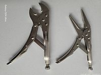 Curved jaw and long nose locking pliers standing open