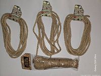 Front view of all four jute ropes showing three 4 m coils with header tags and one 9 m package