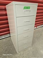 Full view of right side and front of white metal 6-drawer cabinet