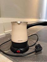 Full view of Goldmaster electric Turkish coffee pot on base with cord