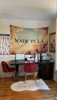 Full view of tapestry hanging above desk showing design and text