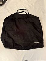 Front view of black Mompush carry bag laid flat