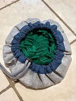 Snuffle mat cinched into pouch, showing drawstring and opening