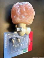 Front view of salt crystal nightlight with two spare bulbs in packaging