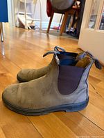 Left side view of both boots showing leather uppers, elastic panels and sole wear