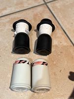 Both pairs of shakers upright on tile floor