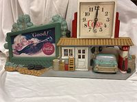 Full view of Coca-Cola service station clock showing billboard, truck, gas pump and clock face