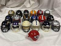 All nineteen mini helmets arranged in three rows with Chiefs helmet separate foreground