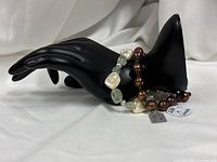 Both bracelets displayed on black mannequin hand