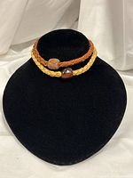 Both braided leather necklaces displayed on bust