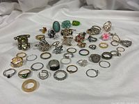 All 50 rings spread out showing size and style variety