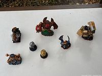 All seven Skylanders pieces laid out on white surface