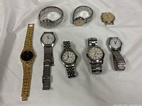 All eight wristwatches laid out on white background
