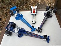 Four model race cars arranged on table