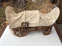 Full view of handmade wooden covered wagon with canvas cover