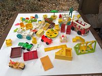 Overview of the complete assortment of Fisher-Price pieces on table