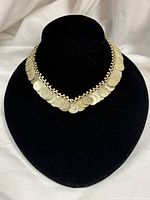 Front view of coin dangle necklace displayed on bust