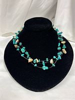 Full view of necklace on bust showing turquoise and abalone chips