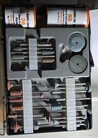 Open case showing all attachments in grey tray and two accessory tubes