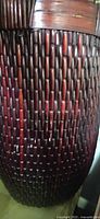 Close-up of burgundy wicker weave and wooden rim