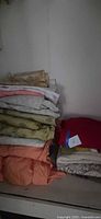Stack of folded linens on shelf
