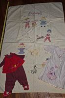 Full view of quilt with outfits laid on top