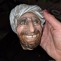 Bossons chalkware head with turban held in hand