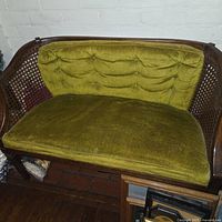 Loveseat front view showing cane back and cushions