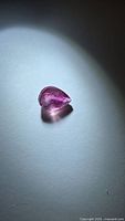 Pear cut pink tourmaline on light background