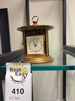 Front view of brass Europa alarm clock showing dial
