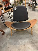Front view of shell chair showing frame and upholstery