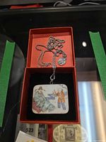 Pendant and chain displayed in red box