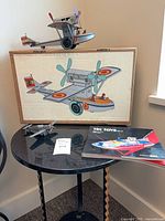 Seaplane displayed on original box lid atop table