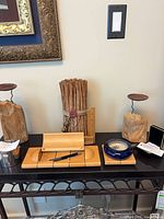 All items on table: candle holders, bark bundle, desk set, glass dish, bronze pin