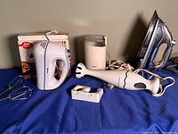 Group view of hand mixer, immersion blender, grinder, iron