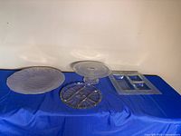 All four glass serving pieces grouped on table