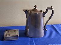 Coffee pot and stacked coasters full view