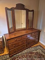 Full view of dresser with attached three-panel mirror