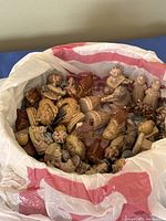 Full plastic bag showing large quantity of Wade figurines