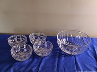Group shot of large crystal bowl with four small bowls