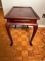 Front view showing full table, cabriole legs and drawer