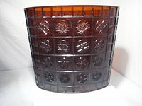 Front view showing amber lucite waste basket with grid and sunburst panels