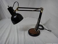 Full view of lamp showing articulating arm, dome shade, base