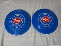 Both blue Post Cereals Frisbee discs front view