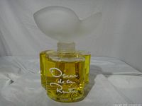 Front view showing logo, segmented body, yellow liquid, frosted stopper