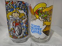 Front view of both tumblers showing Miss Piggy motorcycle design and Kermit balloon design