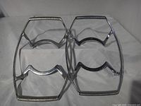 Both Corning Ware metal trivets side by side