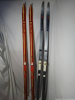 Full view of both pairs of skis standing upright
