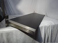 Full view of black-brown shelf with metal brackets